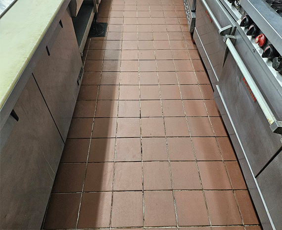 Grease off Commercial Kitchen's cook line floor