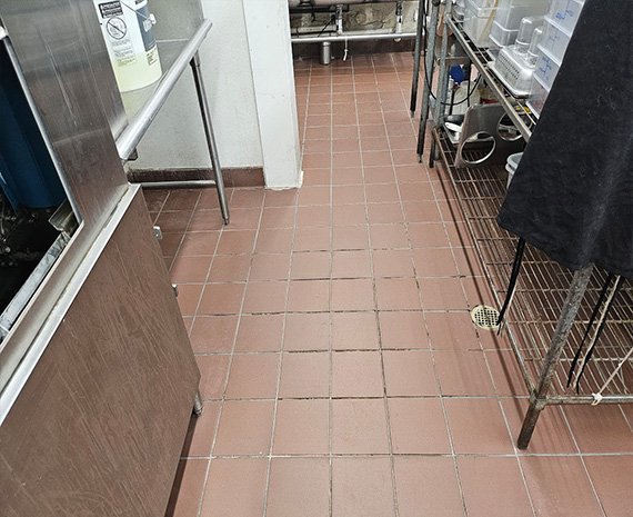 Gaps where grout is missing in commercial kitchen floor