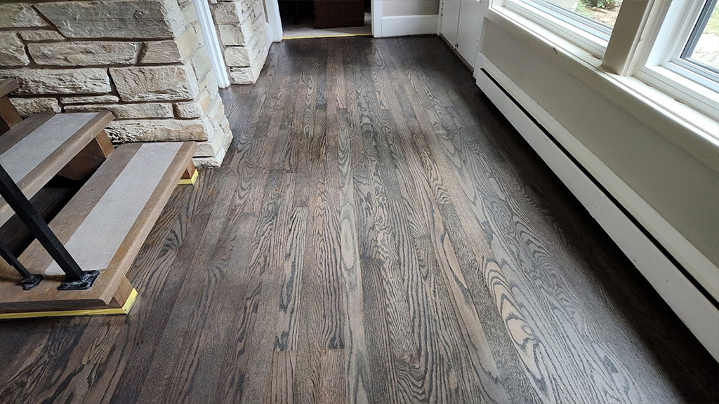 Yardley pet urine stains on hardwood covered and masked with medium gray stain, Morrisville wood floor pet damage fixed with sanding and medium stain color, Bucks Co pet stains masked with sanding and refinishing with medium gray stain