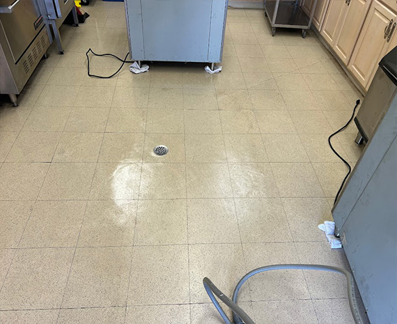 VCT floor under oven island stripped, waxed & blended