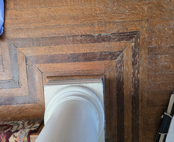 Damaged walnut accent border around column