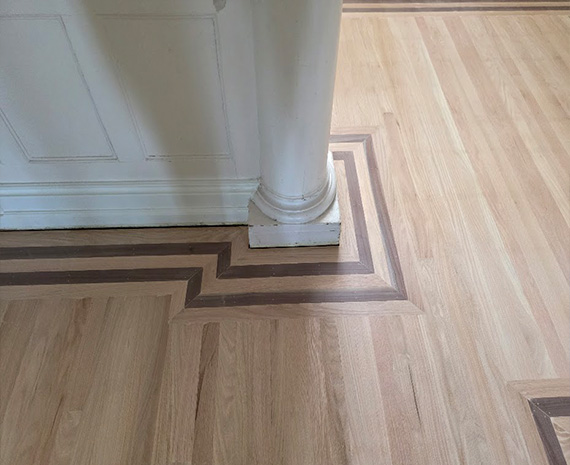 New walnut accent trim around column and near stairs