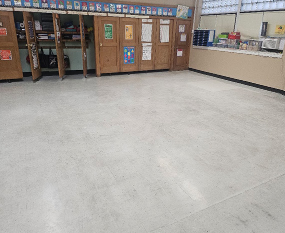 Empty classroom VCT slighted to marks to be waxed over