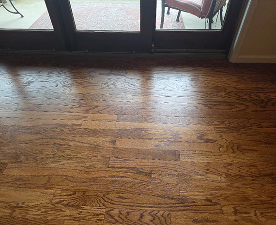 Engineered wood floor after refinishing with dark plant stain completely removed.
