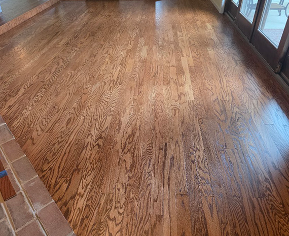 Sunken family room engineered hardwood refinished with long riser blended to match.