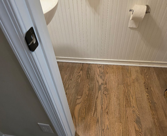 Refinished oak bathroom floor with natural wood tone in Tabernacle, NJ