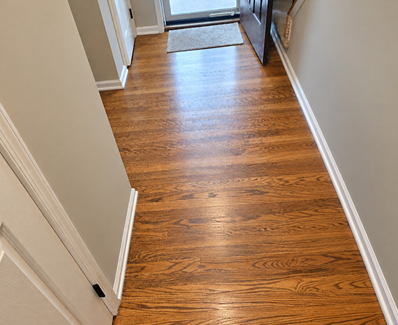 Yellowed oak hallway floor before refinishing in Tabernacle, NJ