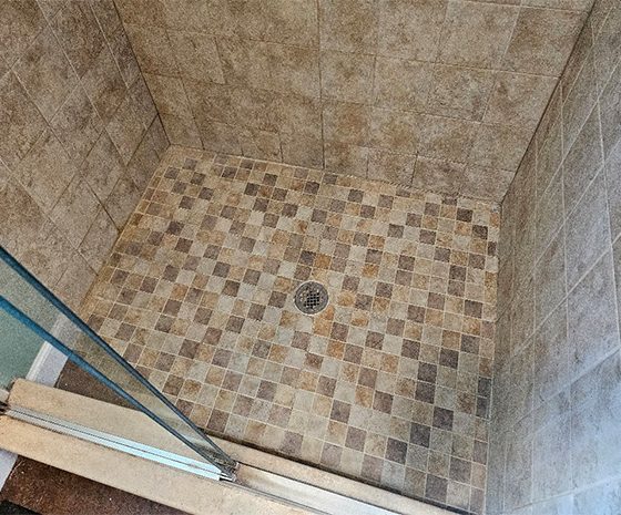 Restored walk-in tile shower in Cape May Court House, NJ, following professional deep cleaning and grout color sealing.